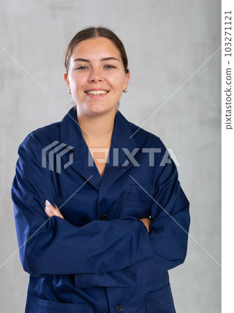 Young woman posing in working uniform in studio Young woman posing in working uniform in studio 103271121