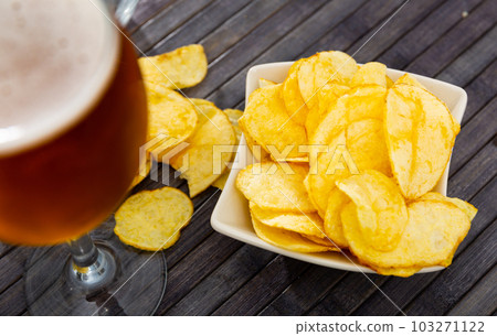 Chips served as snack food with beer Chips served as snack food with beer 103271122