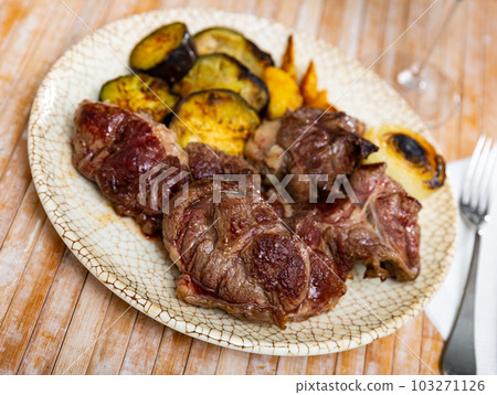 Tasty sliced grilled beef served with potatoes and eggplant Tasty sliced grilled beef served with potatoes and eggplant 103271126