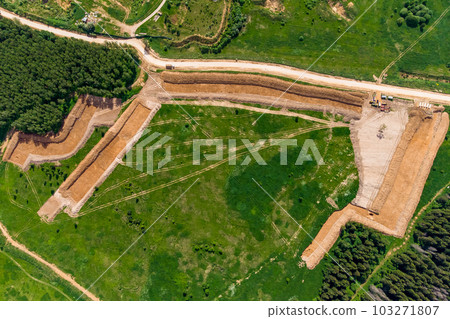 View from a great height at the beginning of the development of a sand pit, removal of overburden View from a great height at the beginning of the development of a sand pit, removal of overburden 103271807
