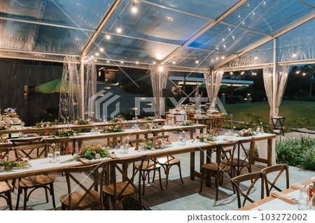 Wedding reception night dinner setup table with beautiful flower decoration. Wedding reception night dinner setup table with beautiful flower decoration. 103272002