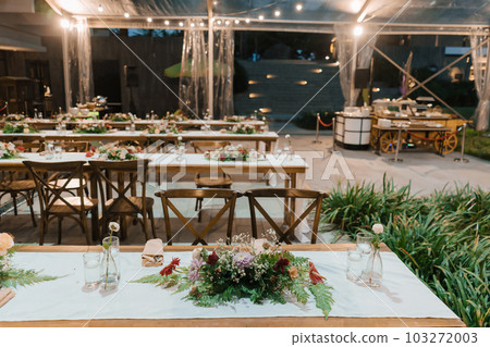 Wedding reception night dinner setup table with beautiful flower decoration. Wedding reception night dinner setup table with beautiful flower decoration. 103272003