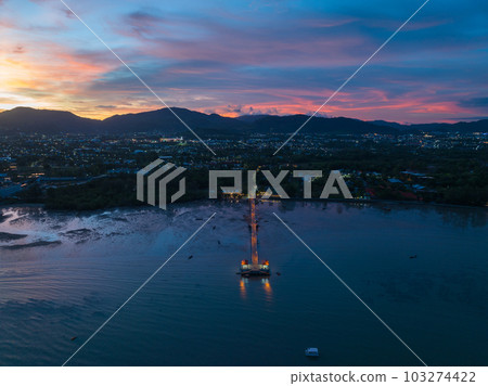 aerial photography cloud above Palai pier at beautiful sunset..Palai pier is next to Chalong pier..fishing boats parking on the beach..colorful cloud above the mountain range background.. 103274422