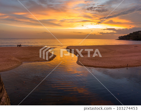 .aerial view stunning reflection of bright golden sky in a canal at Karon beach Phuket. 103274453