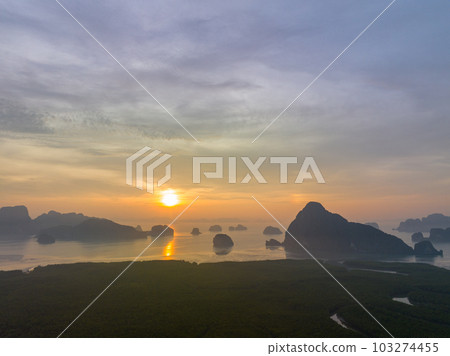aerial view Amazing light of nature cloudscape sky above Samed Nang Chee Phang Nga archipelago. .Imagine a fantasy bright red sky at sunrise from a bird's eye view..tropical landscape background. 103274455