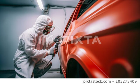 Person Spray Painting Car in Red Color in Special White Painting Box, Wearing Protective Gear. Generative ai 103275409