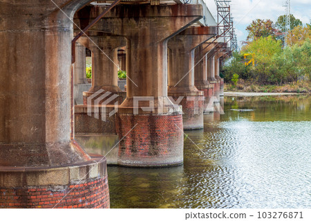 Thick concrete piers supporting the bridge 103276871