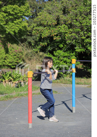 Elementary school girl playing horizontal bar (8 years old) Elementary school girl playing horizontal bar (8 years old) 103277515