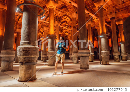 Man tourist enjoying Beautiful cistern in Istanbul. Cistern - underground water reservoir build in 6th century, Istanbul, Turkey, Turkiye 103277943