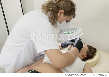 Electrologist Removing Hair On Chin Of Female Face With Electrolysis Procedure, Electric Epilation In Beauty Salon. Hair Removal Treatment. Horizontal Plane 103279077