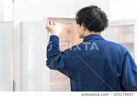 Repairman replacing the packing of the refrigerator Repairman replacing the packing of the refrigerator 103279087