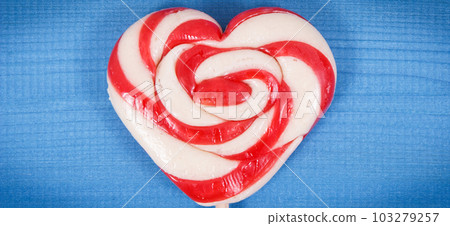 Sweet lollipop in shape of heart as surprise for birthday or other occasion on boards Sweet lollipop in shape of heart as surprise for birthday or other occasion on boards 103279257