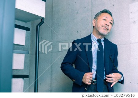 middle aged man in suit 103279516