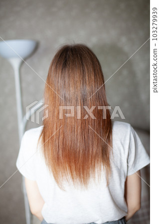 A girl with long, straight and beautiful brown hair. Hair care at home A girl with long, straight and beautiful brown hair. Hair care at home 103279939