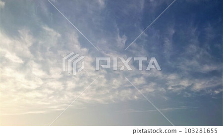 Mysterious pattern of clouds illuminated by the setting sun 103281655