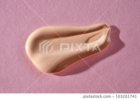 Foundation swatch with spf on a pink background. Foundation swatch with spf on a pink background. 103281743