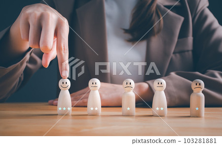 Customer services best excellent business rating experience. Satisfaction survey concept.  Business woman chooses a smiley face on wood doll. 3 Star Satisfaction. or HR chooses the person in the team. 103281881