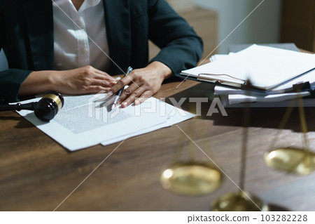 Businesswoman lawyer reading agreement business to signing on contract and working in legal office Businesswoman lawyer reading agreement business to signing on contract and working in legal office 103282228