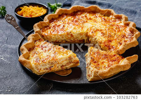 quiche with cheese and bacon filling, top view 103282763