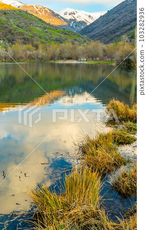 Beautiful alpine lake with reflections of beautiful clouds in the water. Kazgurt district Aksujabagly nature reserve lake syrgan in Kazakhstan Beautiful alpine lake with reflections of beautiful clouds in the water. Kazgurt district Aksujabagly nature reserve lake syrgan in Kazakhstan 103282936