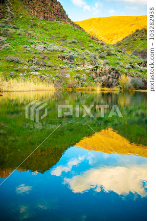 Beautiful alpine lake with reflections of beautiful clouds in the water. Kazgurt district Aksujabagly nature reserve lake syrgan in Kazakhstan Beautiful alpine lake with reflections of beautiful clouds in the water. Kazgurt district Aksujabagly nature reserve lake syrgan in Kazakhstan 103282938