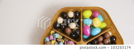 Candies. Assorted colored chocolate dragee. Desserts for candy bars. Small dragees. white background. 103283174