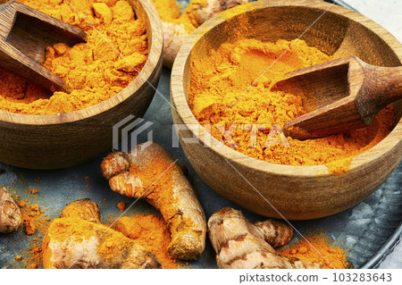 Turmeric root and curcuma powder. Turmeric root and curcuma powder. 103283643