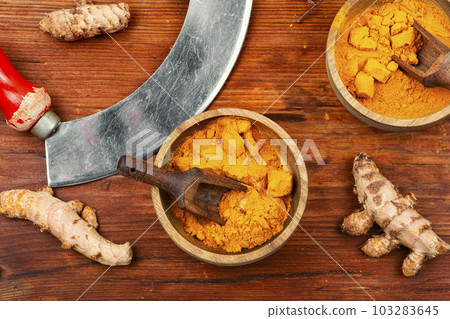 Turmeric powder and root. Turmeric powder and root. 103283645