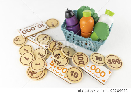Shopping basket and toy food and money. shopping image 103284611