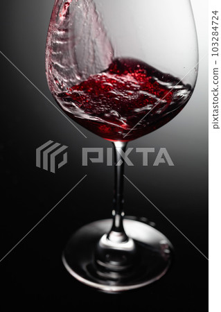 Closeup of red wine pouring. Closeup of red wine pouring. 103284724
