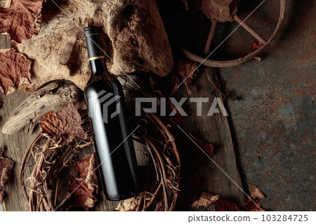Bottle of red wine on a vintage rustic background. Bottle of red wine on a vintage rustic background. 103284725