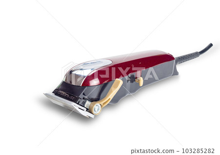 Side view of professional single red corded electric hairclipper isolated on white background. Side view of professional single red corded electric hairclipper isolated on white background. 103285282