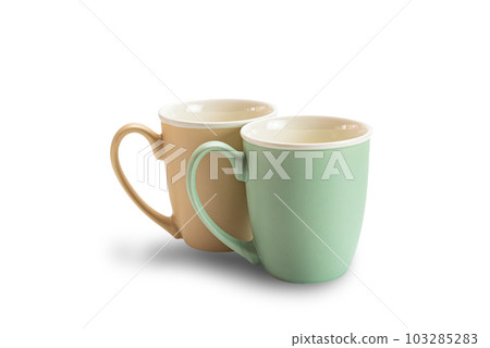 View of two empty ceramic coffee mugs brown and green isolated on white background. 103285283