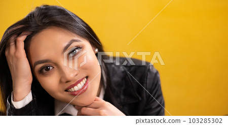 Young Asian woman with a beautiful face - portrait shot against color background Young Asian woman with a beautiful face - portrait shot against color background 103285302