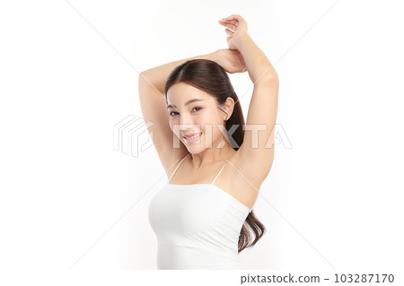 Beautiful Young Asian woman lifting hands up to show off clean and hygienic armpits or underarms on white background, Smooth armpit cleanliness and protection concept 103287170