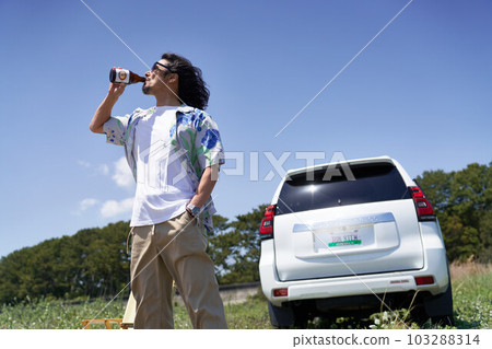 Middle senior man drinking a drink while standing under the blue sky Middle senior man drinking a drink while standing under the blue sky 103288314