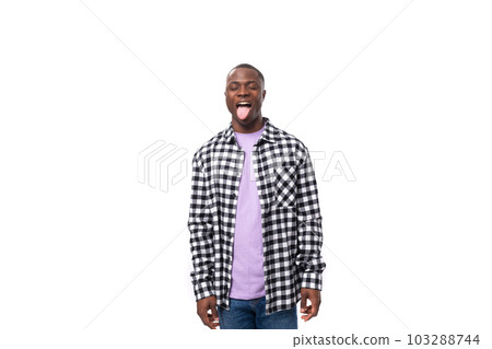 stylish young american guy with short haircut dressed casually with a grimace on a white background 103288744