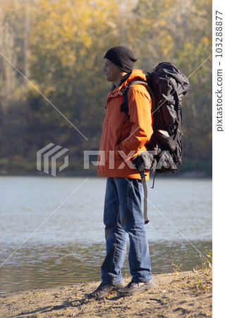 Portrait of traveler man at lake in autumn 103288877
