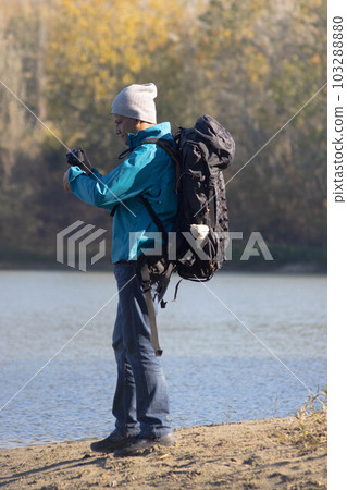 Portrait of traveler man at lake in autumn 103288880