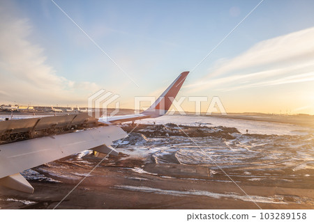 Aircraft's wing and land seen through the illuminator. 103289158