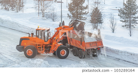 Cleaning and cleaning of roads in the city from snow in winter 103289164