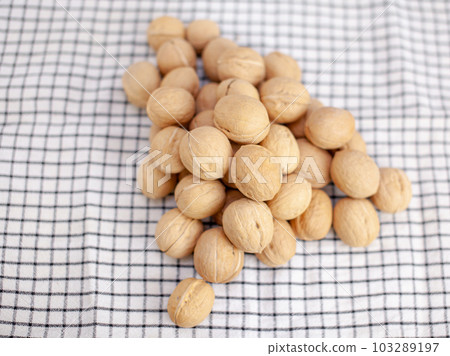 A lot of whole walnuts on a napkin. Healthy, organic and healthy food A lot of whole walnuts on a napkin. Healthy, organic and healthy food 103289197
