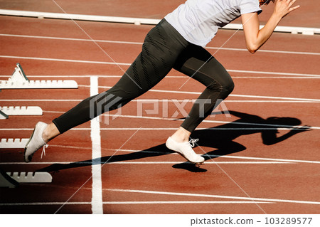 woman sprinter start running from starting blocks 100 metres race in summer athletics championships woman sprinter start running from starting blocks 100 metres race in summer athletics championships 103289577