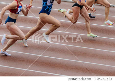 group female athletes runners running together sprint race in track, summer championship athletics 103289585