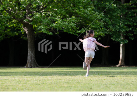 Girls playing on the lawn 103289683