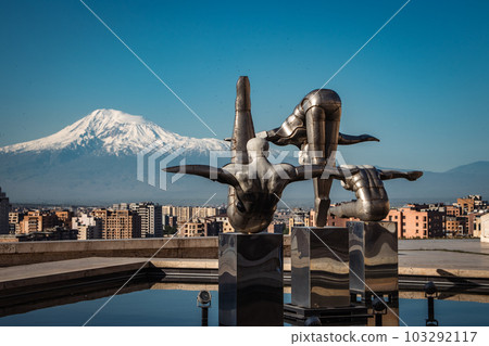 Cityscape with mountain view in the morning time concept photo. Modern art - stainless steel sculptures 103292117