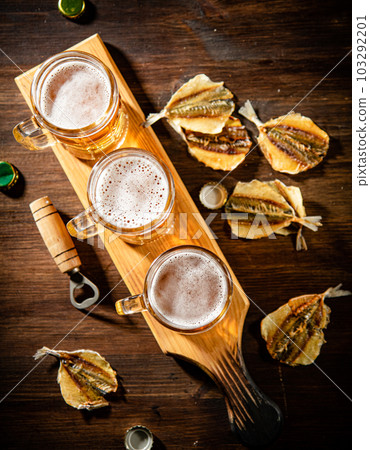 Glasses of beer with dried fish. Glasses of beer with dried fish. 103292201