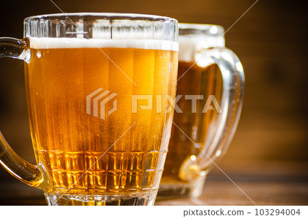 Fresh beer in glasses. Fresh beer in glasses. 103294004