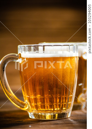 Fresh beer in glasses. 103294005