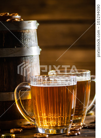 Beer in glasses with salted pretzels. Beer in glasses with salted pretzels. 103294090